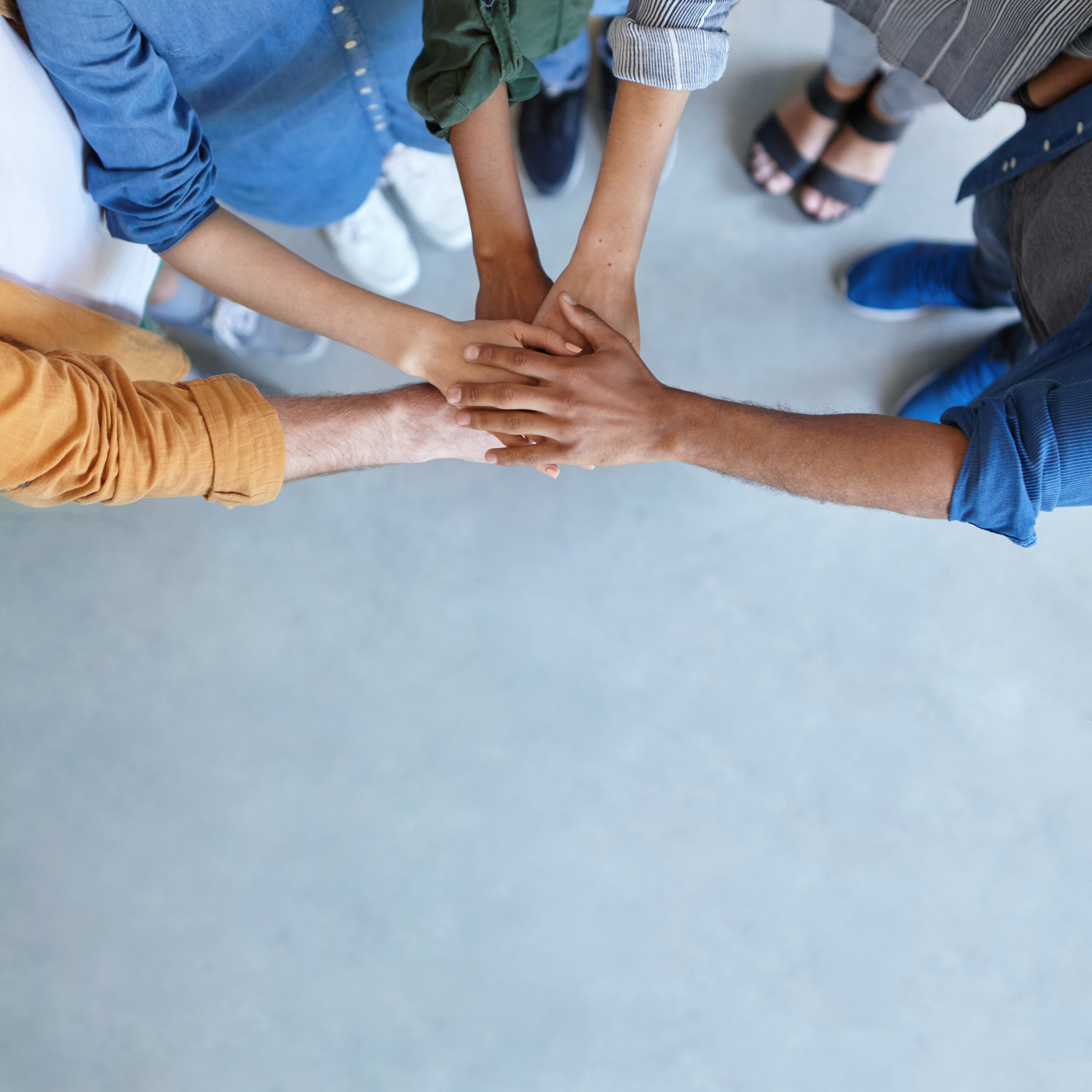 Friendship, partnership, togetherness, collaboration concept. Group of international friends stacking their hands expressing their friendship, agreement and support. People piling their hands Friendship, partnership, togetherness, collaboration concept. Group of international friends stacking their hands expressing their friendship, agreement and support. People piling their hands